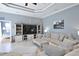 Open-concept living room featuring a large TV, comfortable sofa, and stylish decor creating a relaxing space at 8615 59Th E St, Parrish, FL 34219