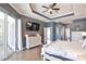 Spacious main bedroom features hardwood flooring, a tray ceiling, and sliding glass door access to the pool area at 8615 59Th E St, Parrish, FL 34219