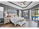 Serene main bedroom features hardwood floors, neutral colors, and sliding glass doors leading to the lanai at 8615 59Th E St, Parrish, FL 34219