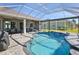 Backyard pool, pavers, and covered patio ideal for entertaining, offering a private outdoor oasis at 8615 59Th E St, Parrish, FL 34219