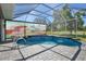 Sparkling pool surrounded by pavers and enclosed by a screen, offering a private outdoor oasis showing a screen at 8615 59Th E St, Parrish, FL 34219