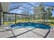 Sparkling pool surrounded by pavers and enclosed by a screen, offering a private outdoor oasis at 8615 59Th E St, Parrish, FL 34219