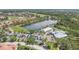 Aerial view of a community with a golf course and lake, surrounded by lush landscaping and well-maintained homes at 9818 Portside Ter, Bradenton, FL 34212