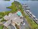 Beautiful waterfront clubhouse, pool, and marina, surrounded by lush greenery and serene water views at 9818 Portside Ter, Bradenton, FL 34212
