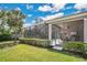 Manicured backyard with a screened lanai, comfortable patio, and lush landscaping at 9818 Portside Ter, Bradenton, FL 34212