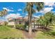 Beautiful backyard with a screened lanai, comfortable patio, and tropical palm trees at 9818 Portside Ter, Bradenton, FL 34212