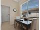 Cozy dining area with tile floors, a window view and access to the laundry room at 9818 Portside Ter, Bradenton, FL 34212
