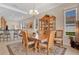 Well-lit dining area with wooden furniture, adjacent to the kitchen and living area at 9818 Portside Ter, Bradenton, FL 34212