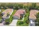 Charming single-story home featuring a red tile roof, attached two-car garage, and meticulously maintained front lawn at 9818 Portside Ter, Bradenton, FL 34212
