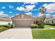 Charming single-story home with a well-manicured lawn, two car garage, and beautiful landscaping at 9818 Portside Ter, Bradenton, FL 34212