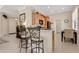 Eat-in kitchen area with black countertop, wood cabinets, stainless appliances and barstool seating at 9818 Portside Ter, Bradenton, FL 34212