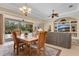Open living and dining area offering seamless transition to the outdoor screened in lanai at 9818 Portside Ter, Bradenton, FL 34212