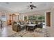 Spacious living room that transitions to the lanai with plush seating, and decorative rug at 9818 Portside Ter, Bradenton, FL 34212