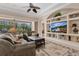 Open-concept living room with custom built-ins, comfortable sofas, and a view of the screened-in lanai at 9818 Portside Ter, Bradenton, FL 34212