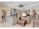 Bright living room featuring neutral tones, a ceiling fan and built-in shelving at 9818 Portside Ter, Bradenton, FL 34212