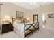 Spacious bedroom with a tray ceiling and access to a bathroom suite at 9818 Portside Ter, Bradenton, FL 34212