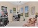 Bright office features a desk, comfortable seating, and plenty of natural light from two large windows at 9818 Portside Ter, Bradenton, FL 34212