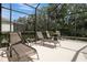 Relax and unwind on the covered patio with lounge chairs overlooking lush landscaping at 9818 Portside Ter, Bradenton, FL 34212