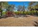 Community playground with a colorful play structure, slide, and swing set, providing recreational space for children at 9818 Portside Ter, Bradenton, FL 34212