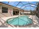 Relaxing screened pool area with brick coping offers the perfect outdoor retreat at 9818 Portside Ter, Bradenton, FL 34212