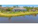 Aerial view of a gorgeous lakeside home with a screened-in pool and manicured landscaping at 16436 Daysailor Trl, Lakewood Ranch, FL 34202
