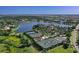 Gorgeous aerial view of community tennis courts and a lake in a luxurious neighborhood at 16436 Daysailor Trl, Lakewood Ranch, FL 34202
