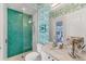 Stylish bathroom with a herringbone tiled shower and decorative wallpaper at 16436 Daysailor Trl, Lakewood Ranch, FL 34202