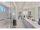 Bright bathroom with white marble, dual sinks, and a spacious glass shower at 16436 Daysailor Trl, Lakewood Ranch, FL 34202