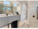 Bright bathroom with a marble countertop, dual sinks, and a shower, creating a luxurious and functional space at 16436 Daysailor Trl, Lakewood Ranch, FL 34202