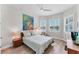 Bright bedroom with waterfront view, stylish decor, and a ceiling fan at 16436 Daysailor Trl, Lakewood Ranch, FL 34202
