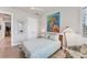 Bright bedroom featuring light hardwood floors and colorful wall art at 16436 Daysailor Trl, Lakewood Ranch, FL 34202