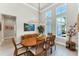 Elegant dining room with high ceilings, modern lighting, and large windows that provide ample natural light at 16436 Daysailor Trl, Lakewood Ranch, FL 34202