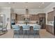 Modern kitchen featuring a large island, stainless steel appliances, and stylish bar stool seating at 16436 Daysailor Trl, Lakewood Ranch, FL 34202