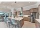 Open concept kitchen boasts a large island with bar seating and seamless connection to outdoor living areas at 16436 Daysailor Trl, Lakewood Ranch, FL 34202