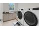 Well-equipped laundry room with modern appliances and storage space at 16436 Daysailor Trl, Lakewood Ranch, FL 34202