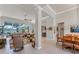 Large living room featuring a view of the pool through the glass doors and large ceiling fan at 16436 Daysailor Trl, Lakewood Ranch, FL 34202