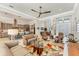 Bright living room featuring modern furnishings, an open layout, and seamless flow to the kitchen and dining areas at 16436 Daysailor Trl, Lakewood Ranch, FL 34202