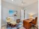 Bright home office with beach-themed art and a comfortable recliner chair at 16436 Daysailor Trl, Lakewood Ranch, FL 34202