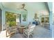 Covered lanai with fire pit, outdoor kitchen, dining area, and comfortable seating, ideal for relaxing at 16436 Daysailor Trl, Lakewood Ranch, FL 34202