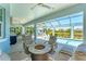 Inviting screened-in lanai features a fire pit, outdoor kitchen and dining area, with a view of the pool and lake at 16436 Daysailor Trl, Lakewood Ranch, FL 34202