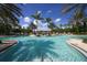 Resort-style pool featuring palm trees, lounge chairs, and scenic views for a relaxing experience at 16436 Daysailor Trl, Lakewood Ranch, FL 34202