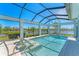 Stunning screened-in pool with picturesque lake views and a luxurious spa at 16436 Daysailor Trl, Lakewood Ranch, FL 34202