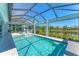 Inviting screened-in pool area with outdoor seating and serene lake backdrop at 16436 Daysailor Trl, Lakewood Ranch, FL 34202
