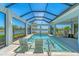 Gorgeous screened-in pool with views of the surrounding lush landscape at 16436 Daysailor Trl, Lakewood Ranch, FL 34202