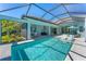 Beautiful screened-in pool area with outdoor kitchen, dining, and lounge seating, perfect for entertaining at 16436 Daysailor Trl, Lakewood Ranch, FL 34202