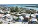 This aerial shot highlights a charming beach house surrounded by other houses with scenic waterfront views at 1107 Shore View Dr, Englewood, FL 34223