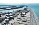 Aerial view highlights a cozy beach house nestled in a waterfront community with scenic coastal views at 1107 Shore View Dr, Englewood, FL 34223