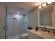 Well-lit bathroom featuring a sleek glass shower, marble countertops, and modern fixtures at 1107 Shore View Dr, Englewood, FL 34223