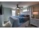 Cozy bedroom featuring a nautical theme, ceiling fan, and natural light from two windows at 1107 Shore View Dr, Englewood, FL 34223