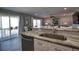 Modern kitchen with stainless steel dishwasher and sink that seamlessly connects to the living room at 1107 Shore View Dr, Englewood, FL 34223